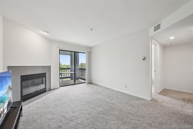 2727 Folsom St Unit 303, Boulder, CO 80304 - unfurnished living room with a tiled fireplace, carpet, and baseboards