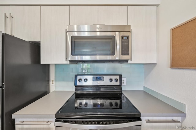 2727 Folsom St Unit 303, Boulder, CO 80304 - kitchen with appliances with stainless steel finishes, tasteful backsplash, and light countertops