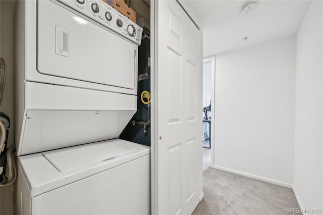 2727 Folsom St Unit 303, Boulder, CO 80304 - washroom with stacked washer / dryer, light colored carpet, and baseboards