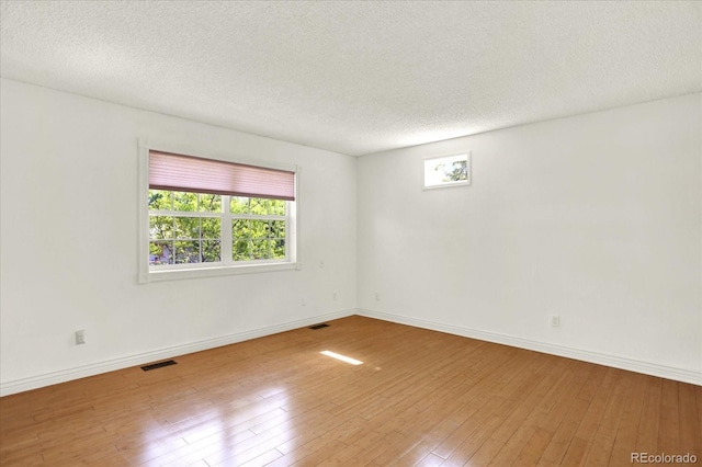 13496 Alcott Way, Broomfield, CO 80020 - empty room with hardwood / wood-style floors, baseboards, and a textured ceiling