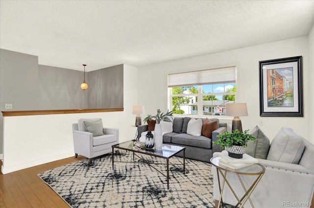 13496 Alcott Way, Broomfield, CO 80020 - living room featuring a textured ceiling, wood finished floors, and baseboards
