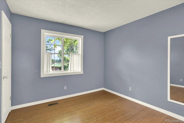 13496 Alcott Way, Broomfield, CO 80020 - spare room featuring wood finished floors, baseboards, and a textured ceiling