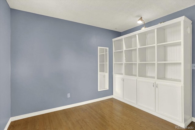 13496 Alcott Way, Broomfield, CO 80020 - spare room featuring wood finished floors, baseboards, and a textured ceiling