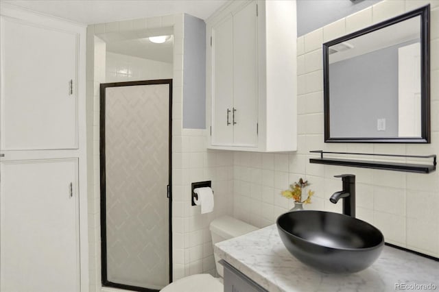 13496 Alcott Way, Broomfield, CO 80020 - full bathroom featuring tile walls, a shower stall, toilet, and vanity