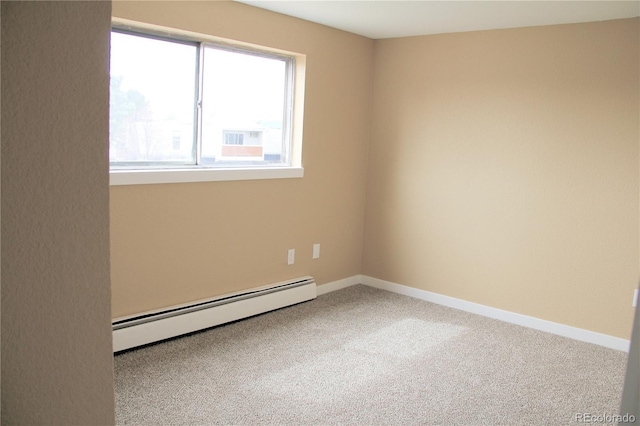875 S Quebec St Unit 25, Denver, CO 80247 - spare room with a baseboard heating unit, carpet flooring, and baseboards