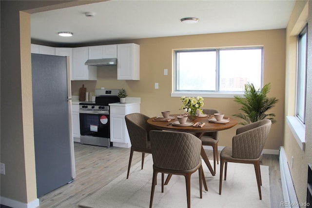 875 S Quebec St Unit 25, Denver, CO 80247 - dining room featuring light wood-style flooring, a baseboard radiator, and baseboards