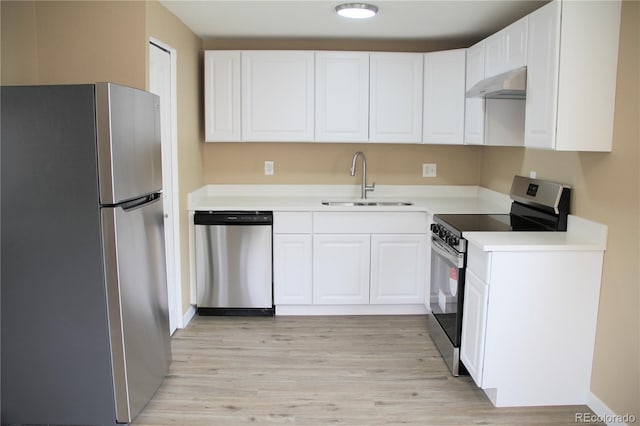 875 S Quebec St Unit 25, Denver, CO 80247 - kitchen featuring appliances with stainless steel finishes, exhaust hood, a sink, white cabinets, and light wood finished floors