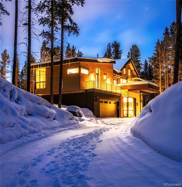 55 Blue Flag Dr, Breckenridge, CO 80424 - snow covered rear of property featuring a garage, a balcony, and driveway