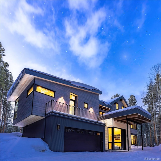 55 Blue Flag Dr, Breckenridge, CO 80424 - snow covered back of property featuring a balcony and a garage
