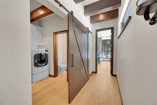 55 Blue Flag Dr, Breckenridge, CO 80424 - clothes washing area with washer / dryer, a barn door, cabinet space, and light wood-type flooring