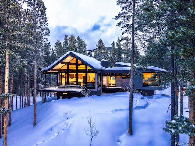 55 Blue Flag Dr, Breckenridge, CO 80424 - snow covered rear of property with a porch