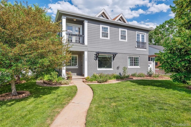 1100 S Garfield St, Denver, CO 80210 - view of front facade featuring a balcony and a front lawn