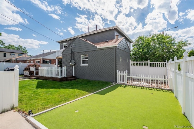 1100 S Garfield St, Denver, CO 80210 - back of house with a fenced backyard, a putting green, and a wooden deck