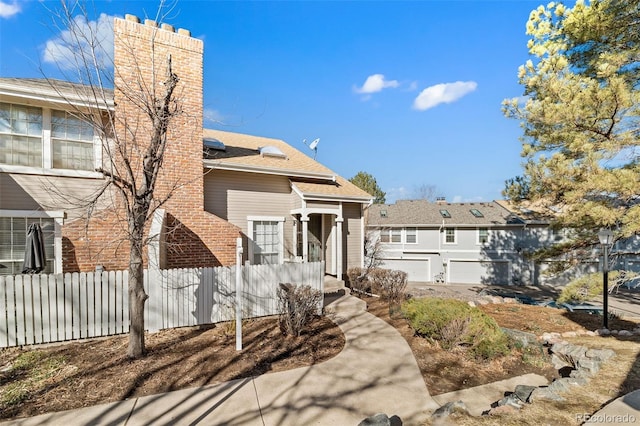 view of front of house featuring a chimney and fence