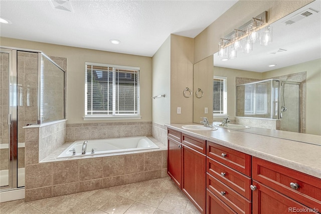 full bathroom with a bath, a wealth of natural light, a shower stall, and visible vents