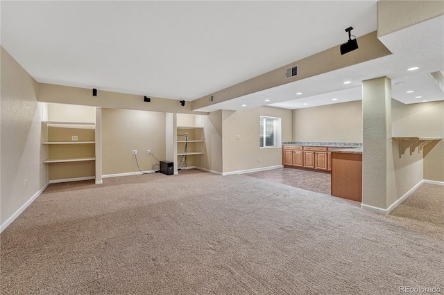 unfurnished living room with light carpet, visible vents, baseboards, and recessed lighting