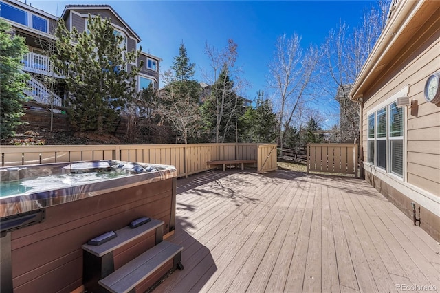 wooden deck featuring a hot tub