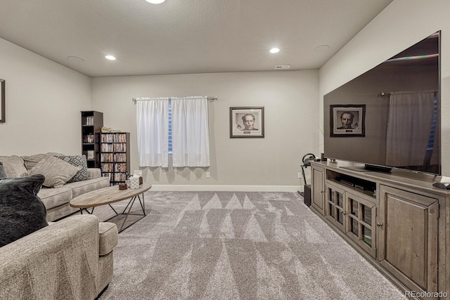 living room with a textured ceiling and light carpet