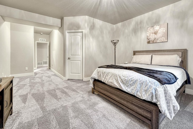 bedroom featuring carpet floors and a textured ceiling