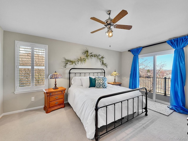 carpeted bedroom with multiple windows, ceiling fan, baseboards, and access to outside