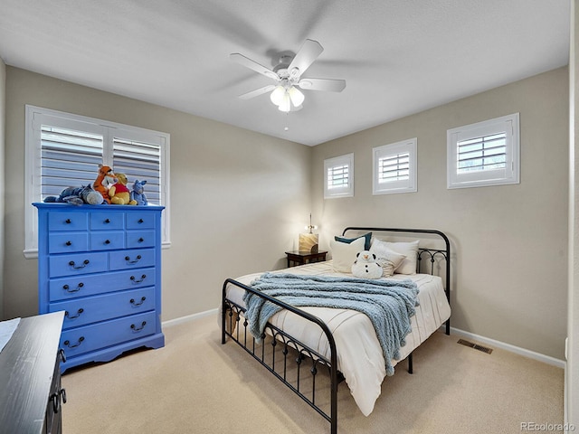 bedroom with visible vents, multiple windows, baseboards, and carpet