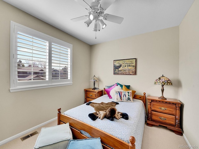 bedroom featuring visible vents, baseboards, carpet, and a ceiling fan