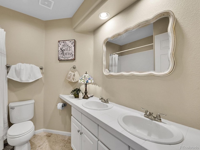 full bathroom featuring toilet, baseboards, visible vents, and a sink