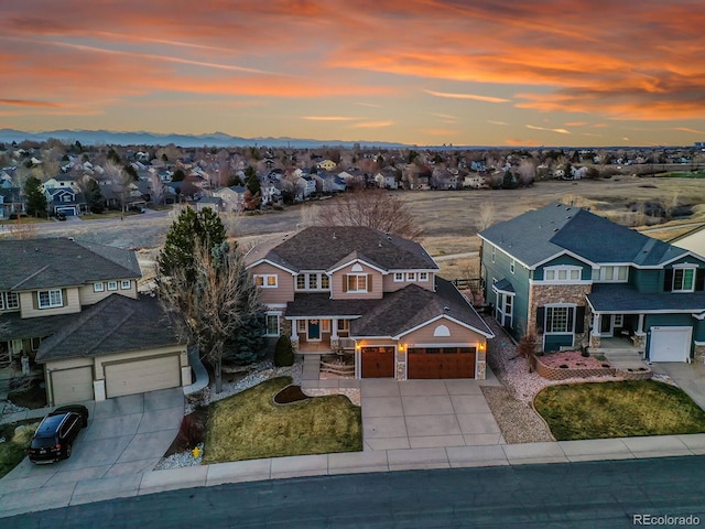 aerial view at dusk featuring a residential view