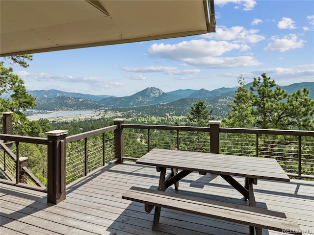 1141 Koral Ct, Estes Park, CO 80517 - wooden deck featuring outdoor dining space and a water and mountain view