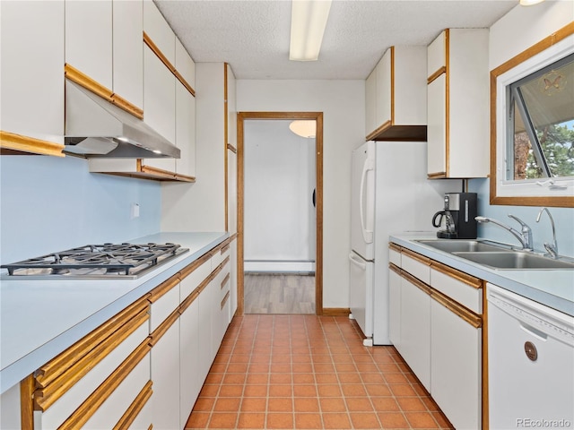 1141 Koral Ct, Estes Park, CO 80517 - kitchen with white appliances, a sink, a baseboard heating unit, under cabinet range hood, and light countertops
