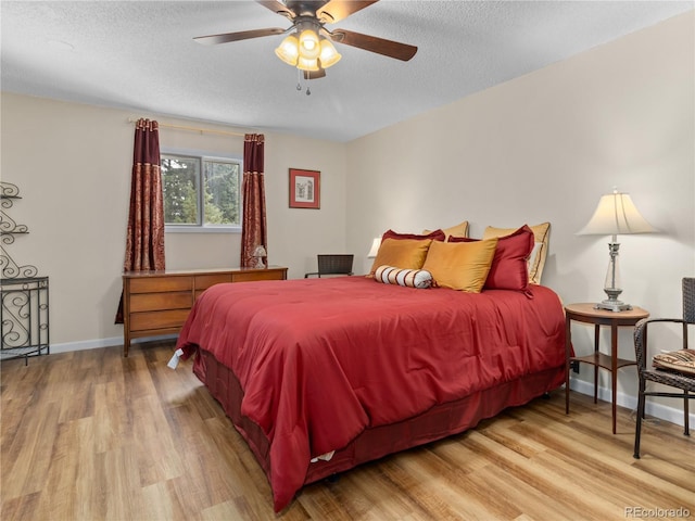 1141 Koral Ct, Estes Park, CO 80517 - bedroom featuring wood finished floors, a textured ceiling, baseboards, and a ceiling fan
