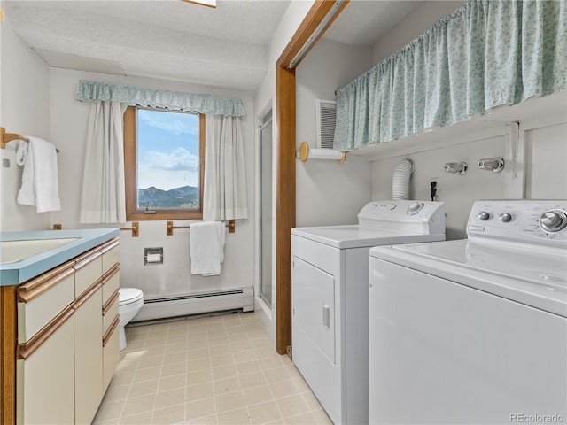 1141 Koral Ct, Estes Park, CO 80517 - laundry room featuring a baseboard radiator, separate washer and dryer, and light tile patterned flooring