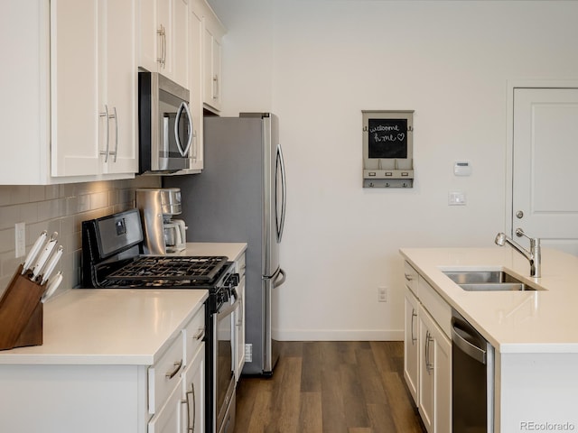 kitchen with stainless steel appliances, tasteful backsplash, white cabinetry, dark wood-type flooring, and sink