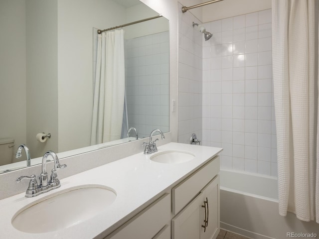 bathroom with shower / tub combo and dual bowl vanity