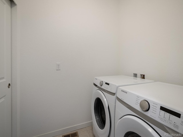 laundry area featuring independent washer and dryer, washer hookup, and light tile floors