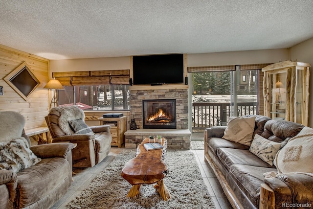 405 Four Oclock Rd Unit 15-A, Breckenridge, CO 80424 - living area with a textured ceiling, a stone fireplace, wood walls, and tile patterned floors