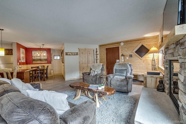 405 Four Oclock Rd Unit 15-A, Breckenridge, CO 80424 - living room with wooden walls, a textured ceiling, tile patterned floors, and a fireplace
