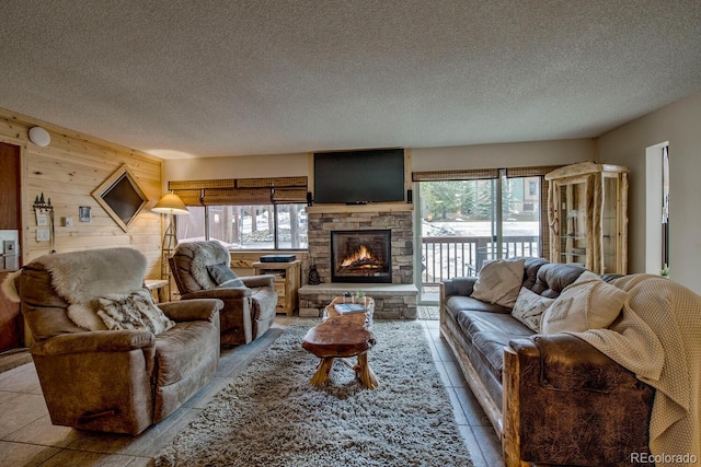 405 Four Oclock Rd Unit 15-A, Breckenridge, CO 80424 - living area with healthy amount of natural light, a textured ceiling, a fireplace, and wood walls