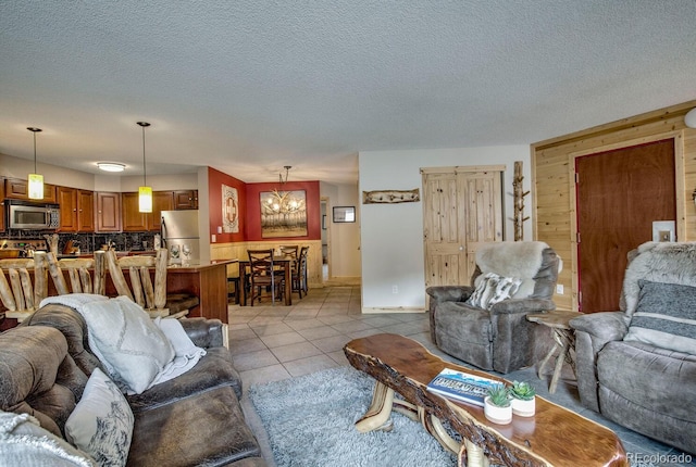 405 Four Oclock Rd Unit 15-A, Breckenridge, CO 80424 - living area featuring a textured ceiling, wooden walls, and light tile patterned floors