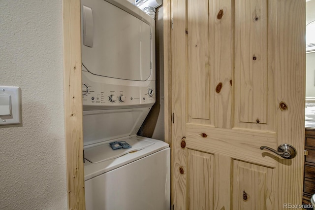 405 Four Oclock Rd Unit 15-A, Breckenridge, CO 80424 - washroom with stacked washer and clothes dryer and a textured wall