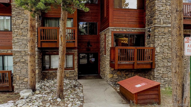 405 Four Oclock Rd Unit 15-A, Breckenridge, CO 80424 - doorway to property featuring stone siding and a balcony