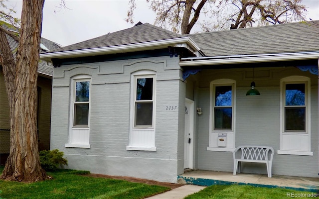 exterior space featuring a shingled roof