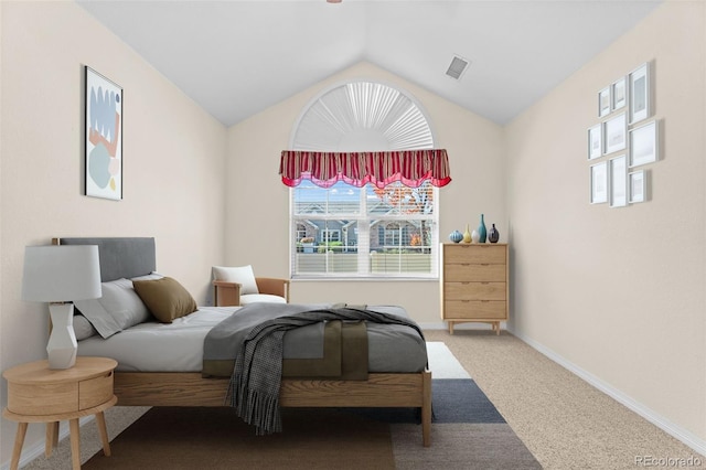 bedroom featuring vaulted ceiling and carpet floors