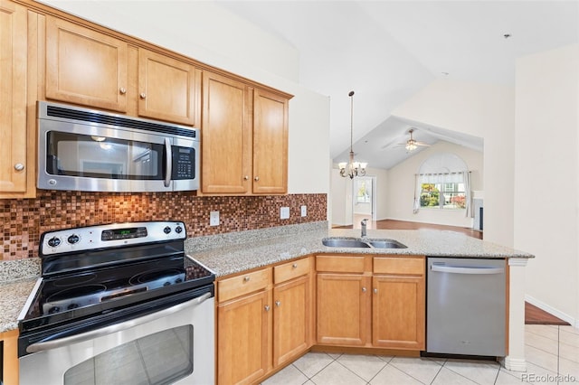 kitchen with appliances with stainless steel finishes, sink, backsplash, kitchen peninsula, and vaulted ceiling