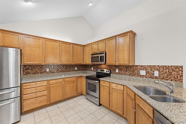 kitchen featuring light stone countertops, sink, appliances with stainless steel finishes, and backsplash