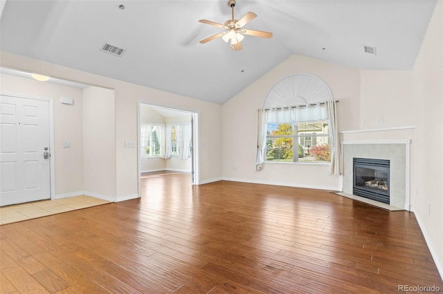 unfurnished living room featuring wood-type flooring and plenty of natural light