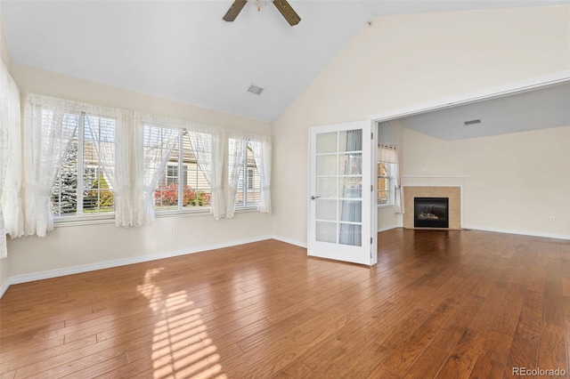 unfurnished living room featuring hardwood / wood-style floors, a fireplace, high vaulted ceiling, and ceiling fan