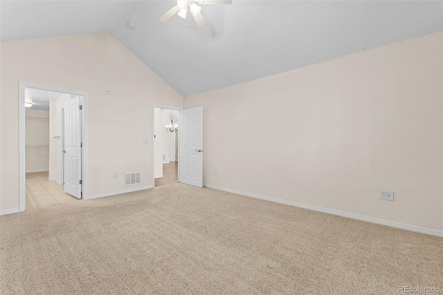 unfurnished bedroom with high vaulted ceiling, a walk in closet, light colored carpet, and ceiling fan