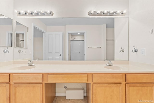 bathroom with vanity, walk in shower, and tile patterned floors