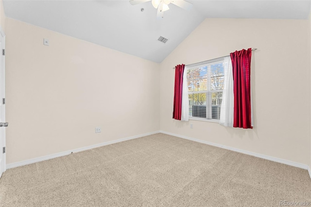 spare room featuring ceiling fan, carpet, and vaulted ceiling